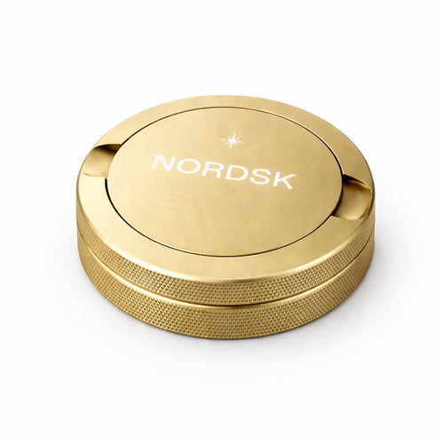 Champagne Gold metal snus tin with NORDSK branding on white background, designed in Sweden