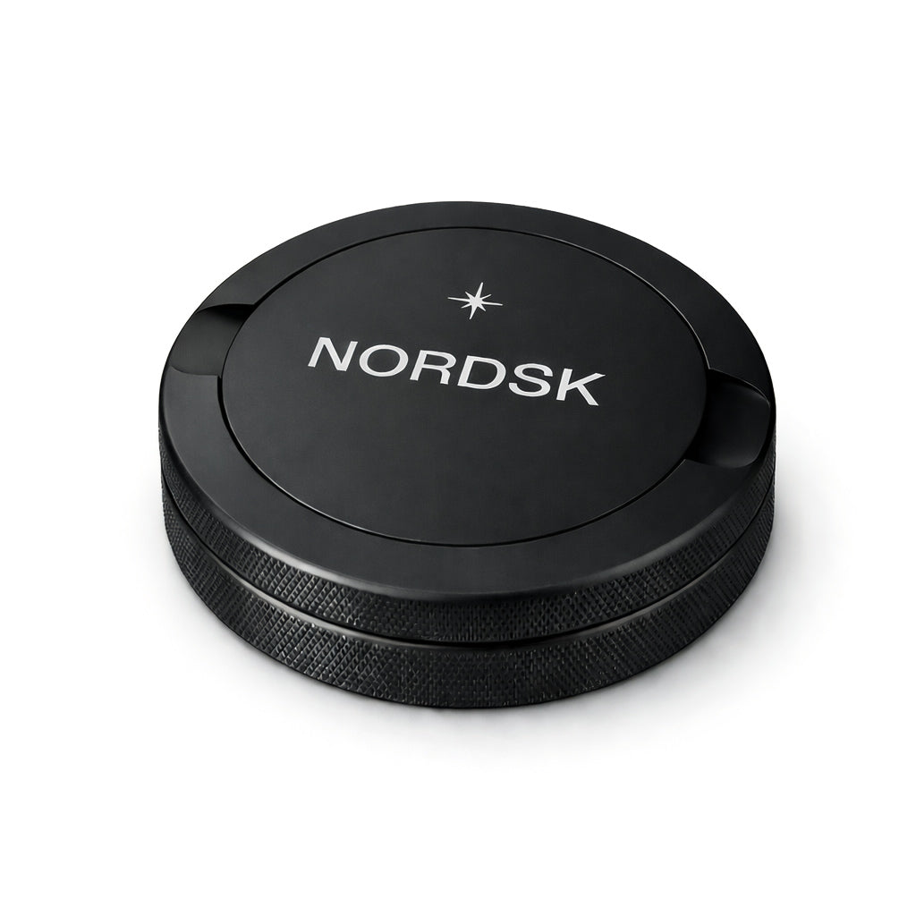 NORDSK Matte Black metal snus tin on white background, designed in Sweden